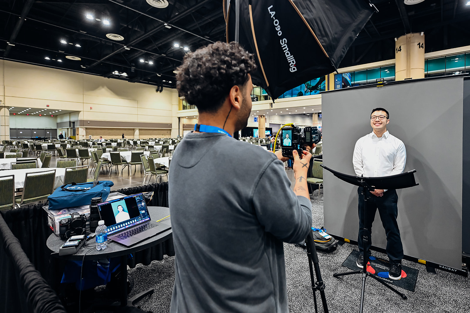 Wide view of the headshot lounge setup with softbox lighting and backdrop